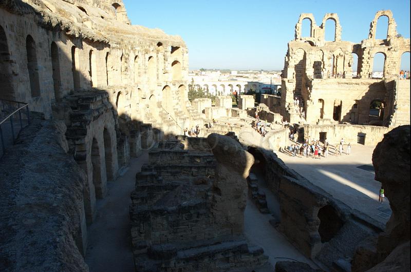 DSC_3513.jpg - El Djem (Latin Thysdrus) is a town in Mahdia Governorate, Tunisia. It is home to some of the most impressive Roman remains in Africa. El Djem is famous for its amphitheatre (often incorrectly called "a coliseum"), capable of seating 35,000 spectators. Only Rome's Colosseum (about 45,000 spectators) and the ruined theatre of Capua are larger. The amphitheatre at El Djem was built by the Romans under proconsul Gordian, who was acclaimed Emperor at Thysdrus, around 238 and was probably mainly used for gladiator shows and chariot races (like in Ben-Hur). It is also possible that construction of the amphitheatre was never finished.Until the 17th century it remained more or less whole. From then on its stones were used for building the nearby village of El Djem and transported to the Great Mosque in Kairouan, and at a tense moment during struggles with the Ottomans, the Turks used cannons to flush rebels out of the amphitheatre.The ruins of the amphitheatre were declared a World Heritage Site in 1979.